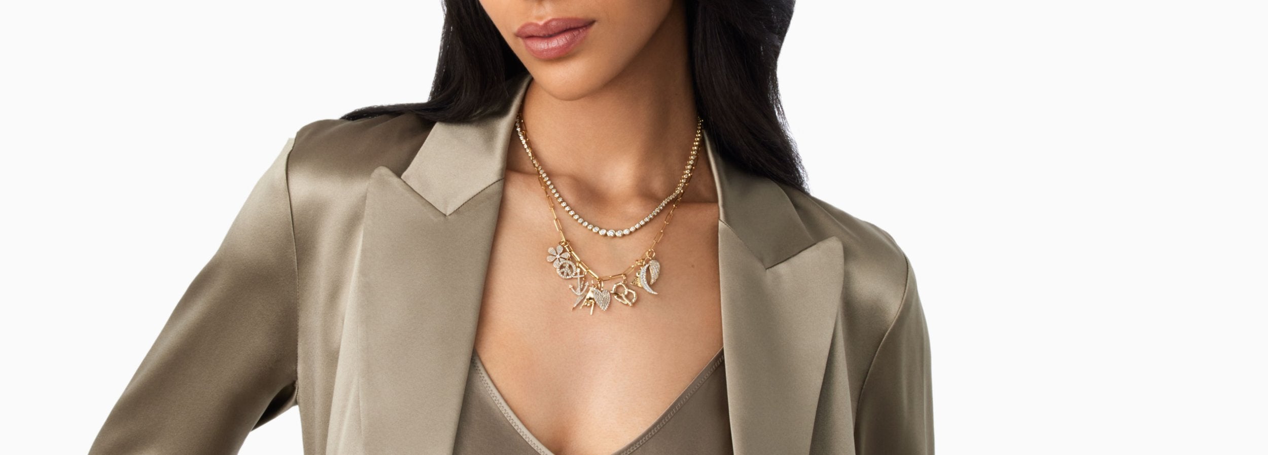 woman wearing collection of gemstone charms on chain around neck